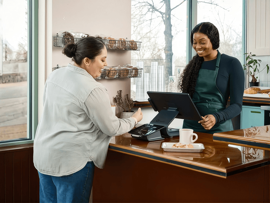 A customer paying at a cafe counter using Invota-ready point of sale